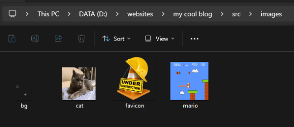 The images folder showing thumbnails of a bg.gif image of stars, cat.jpg of a gray cat sitting on a blue pillow, favicon.png of an orange traffic cone with a yellow construction helmet hung over it and a sign that reads UNDER CONSTRUCTION, and mario.jpg of a screenshot of Super Mario Bros. on NES